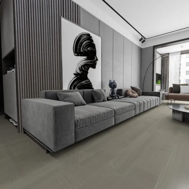 Modern living room with a grey sofa, abstract art, and large windows.