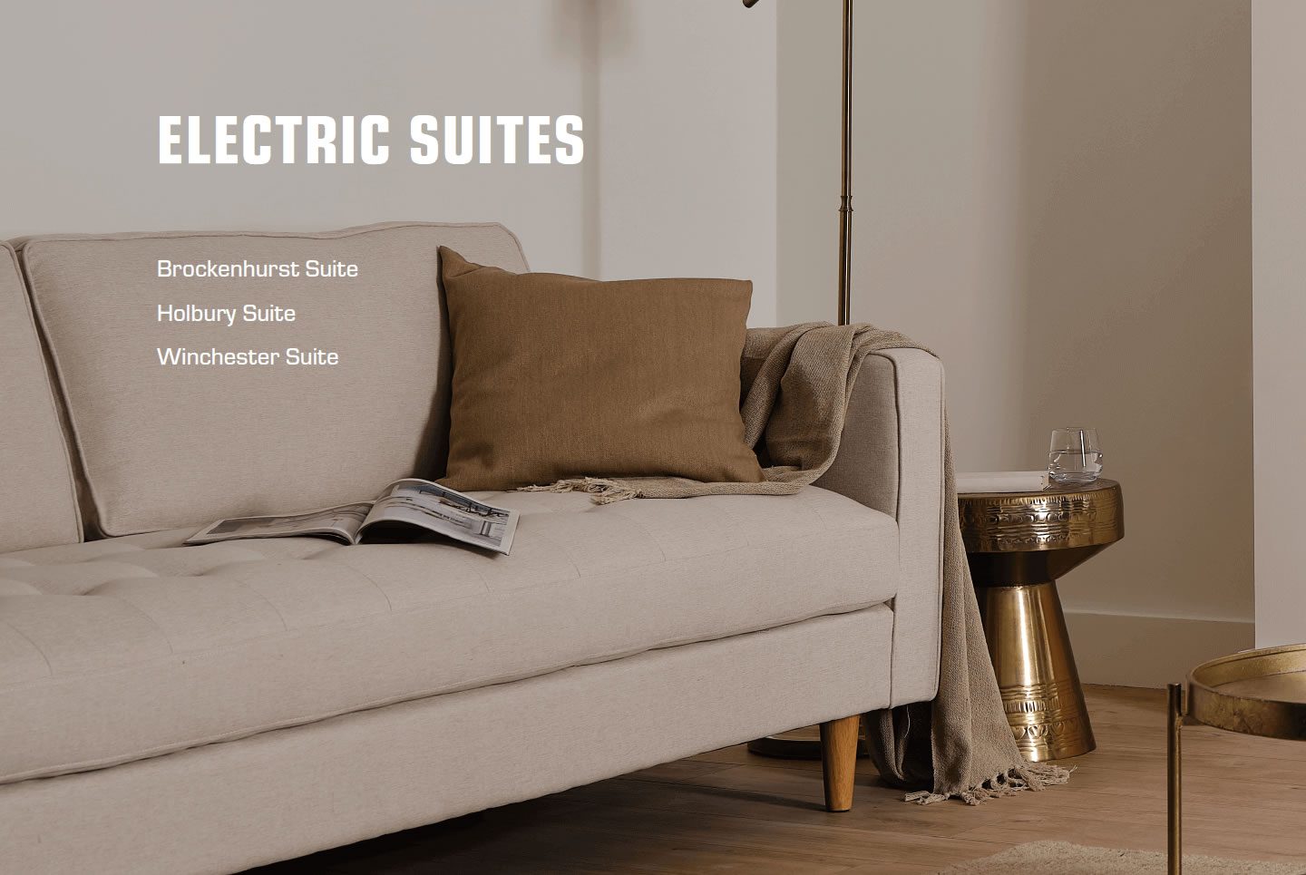 A neutral-toned sofa with a cushion and a small side table beside it.