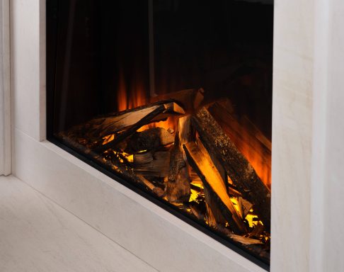 Glowing logs with embers in a modern electric fireplace.