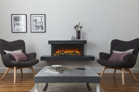Modern living room with two black chairs, a coffee table, and an electric fireplace.