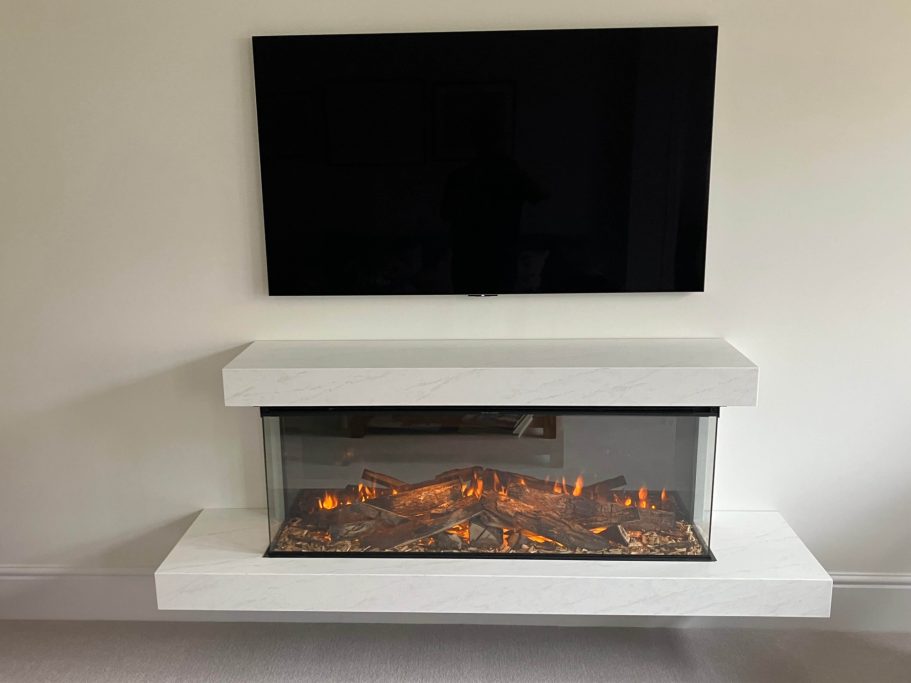 Modern wall-mounted fireplace with a white mantel and glowing logs beneath a TV.
