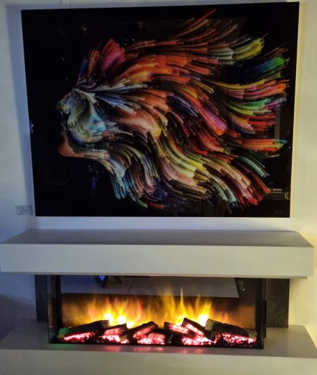 A vibrant abstract artwork above a modern fireplace.