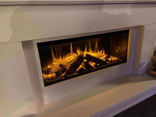 Electric fireplace with glowing logs and flickering flames in a modern white mantel.