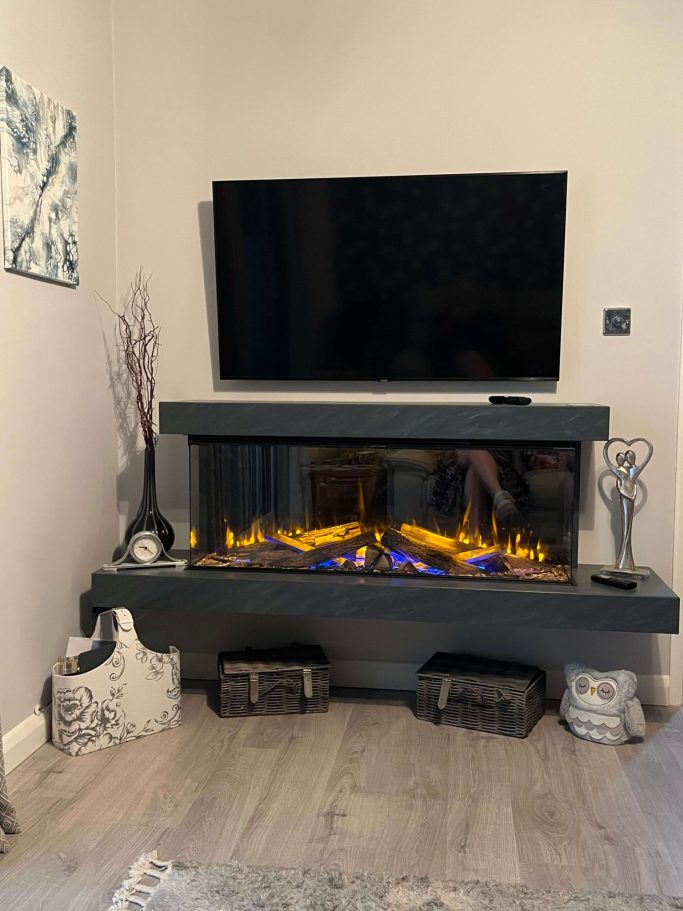 Modern living room with a sleek fireplace and wall-mounted TV above it.