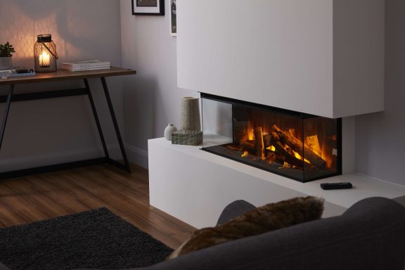 Modern living room with a sleek electric fireplace, wooden flooring, and a simple table.