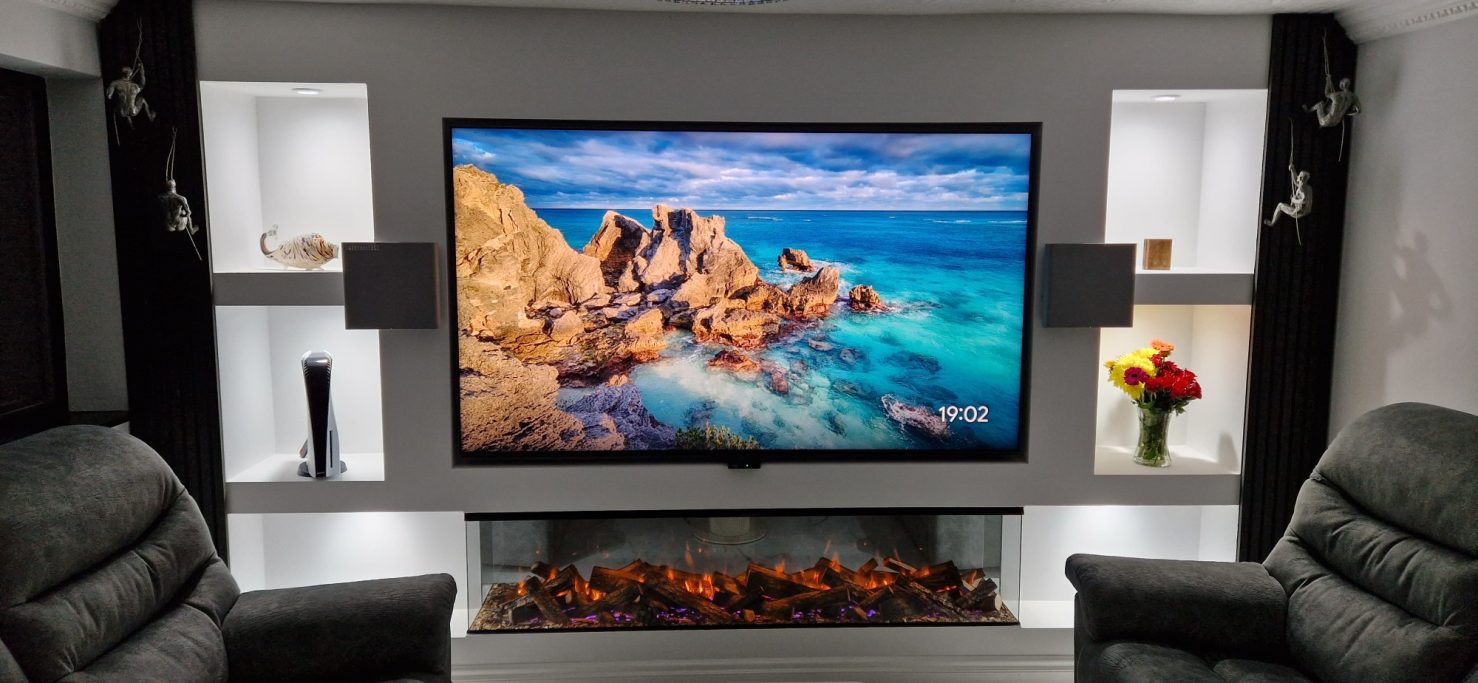 Modern living room with a large TV  and a decorative modern electric fireplace.