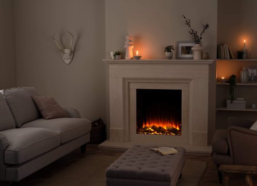 Cozy living room with a fireplace, candles, and comfortable furniture.