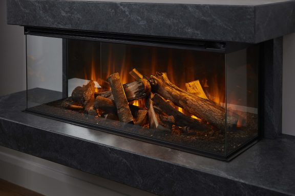 Modern electric fire suite with real wood logs and flames inside a sleek stone effect surround.