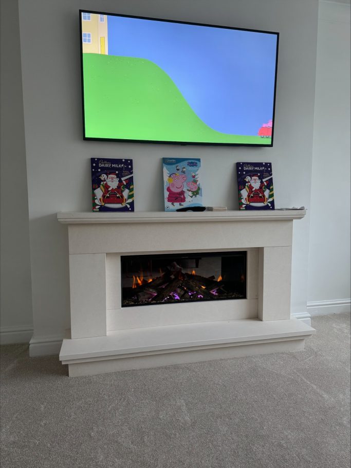 Media wall fire in a stone fireplace